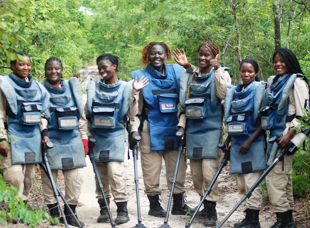 MAG Deminers with PPE smiling at camera